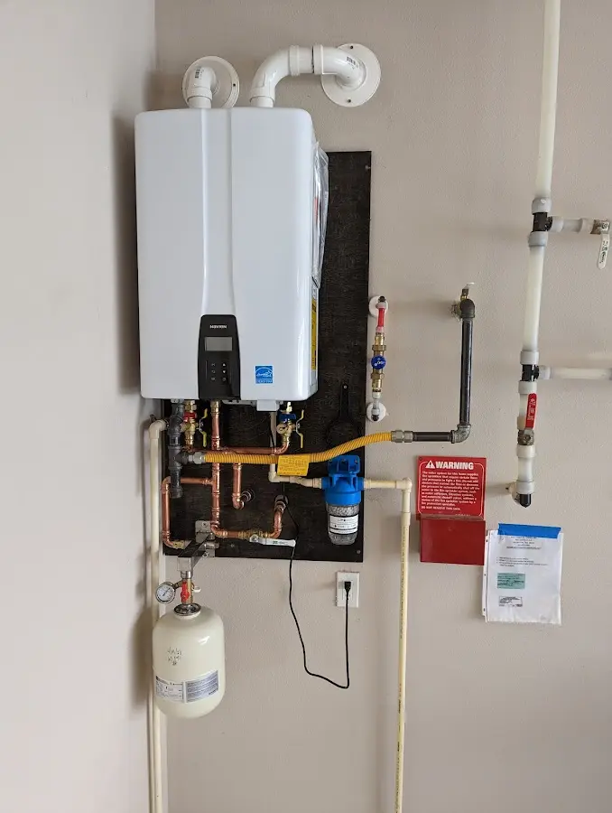 Professional plumber installing copper piping in a Ross home